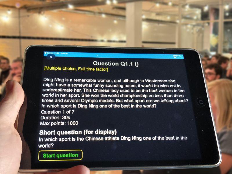 Quizmaster holding a tablet running the quizmaster app