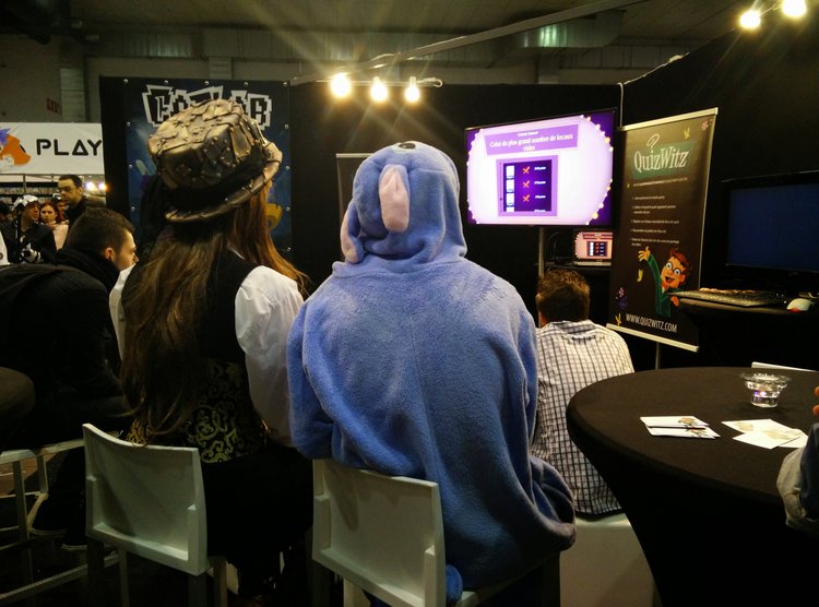 A picture of people at a conference stand playing QuizWitz