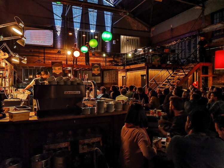 A picture of a group of people playing QuizWitz in a bar