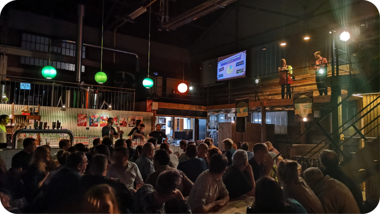 A QuizWitz Live event with a quizmaster on stage